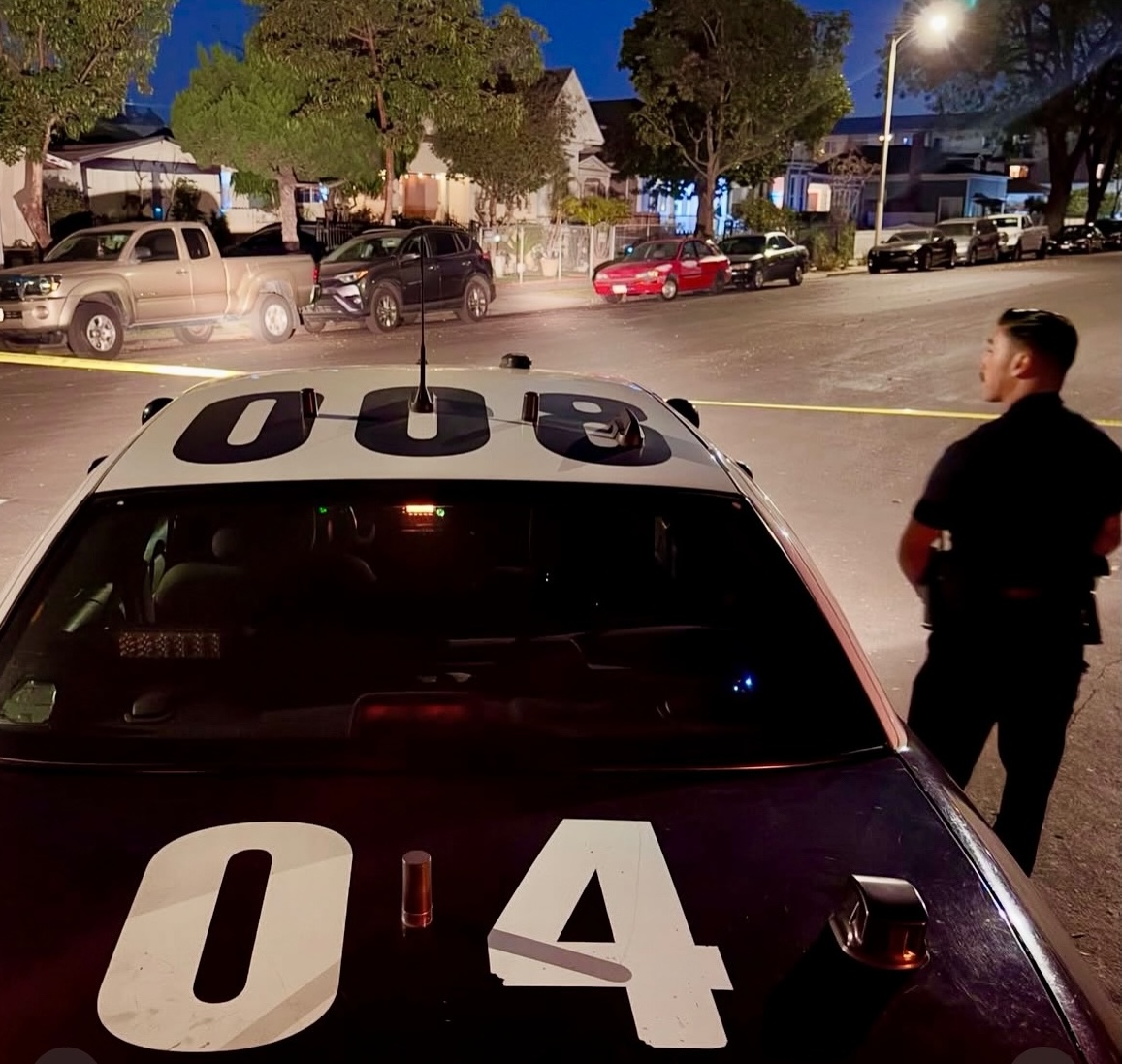 A Los Angeles police officer surveys a crime scene.